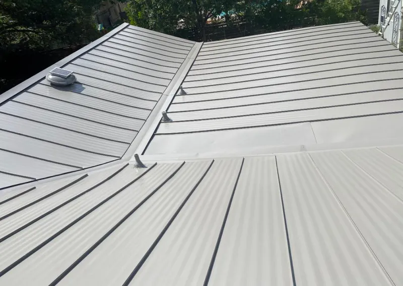 Solar attic fan installed on a metal roof for Roof Ventilation in Jackson